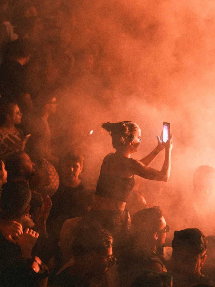 A festival crowd under stage lights
