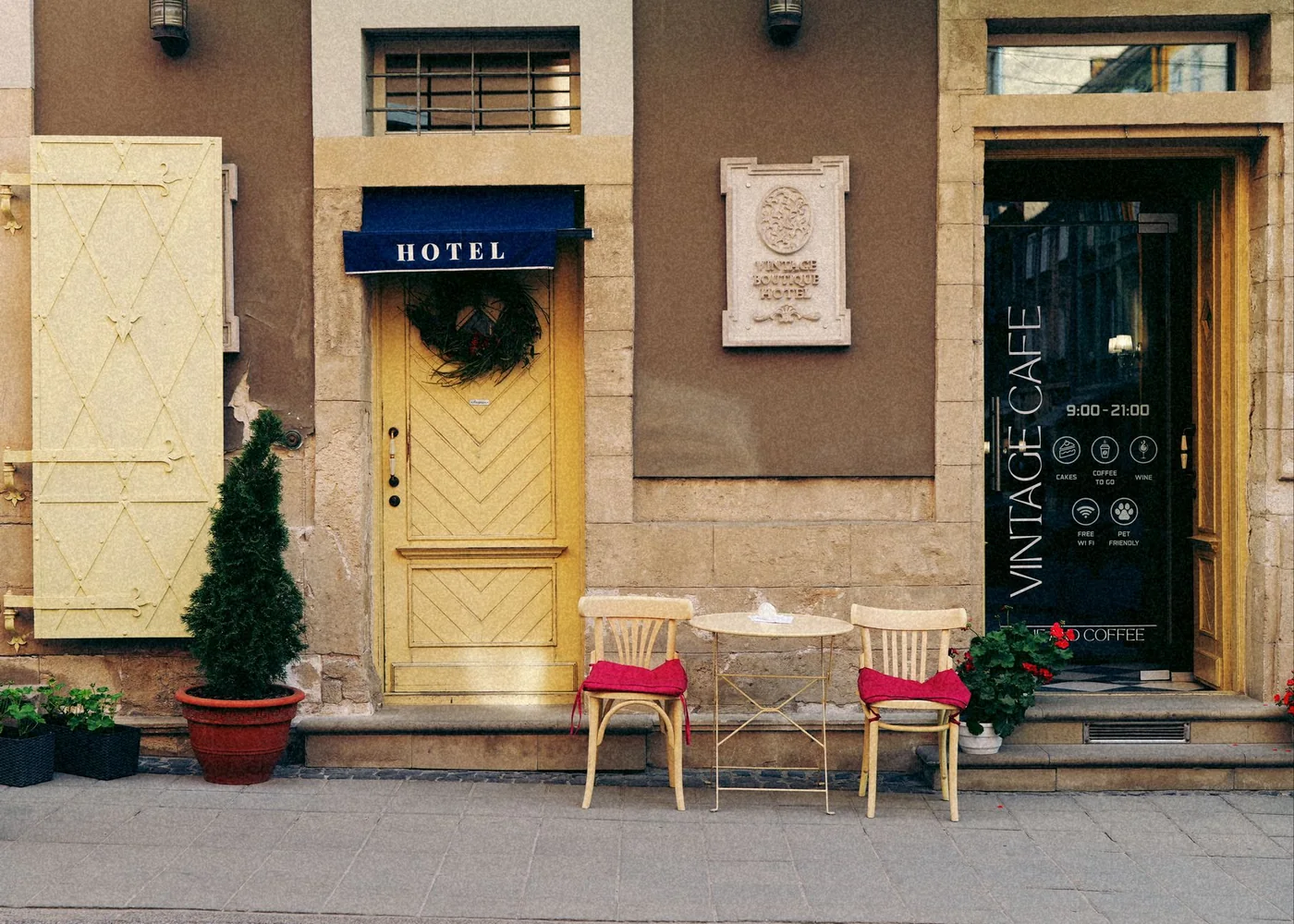 A entrada de um hotel pequeno com duas cadeiras vermelhas