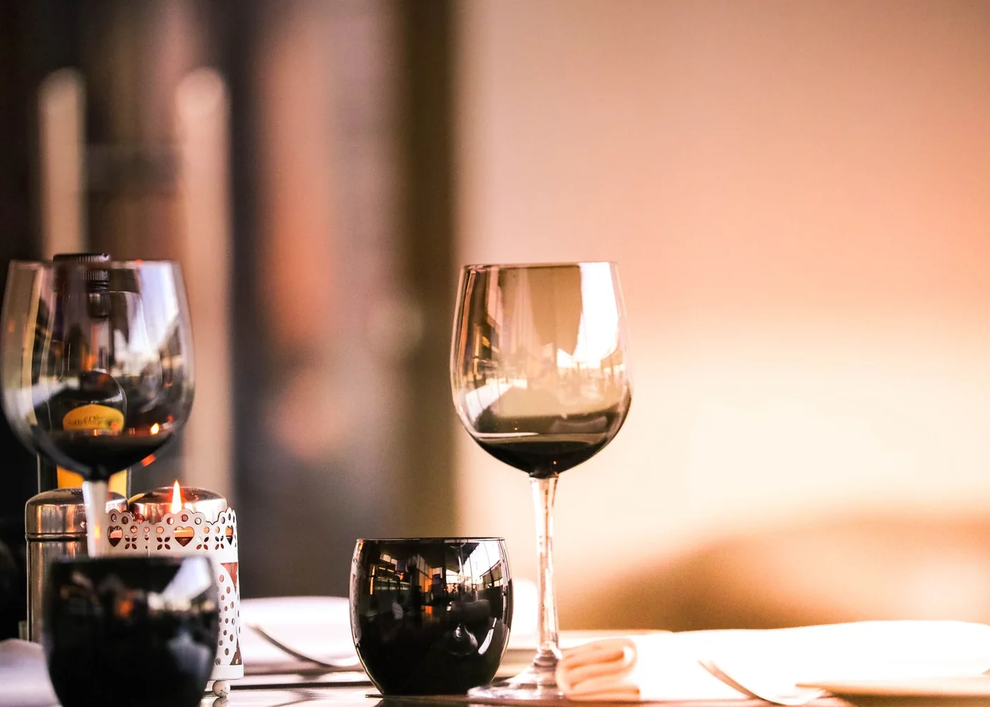 Una mesa de restaurante con copas de vino al atardecer